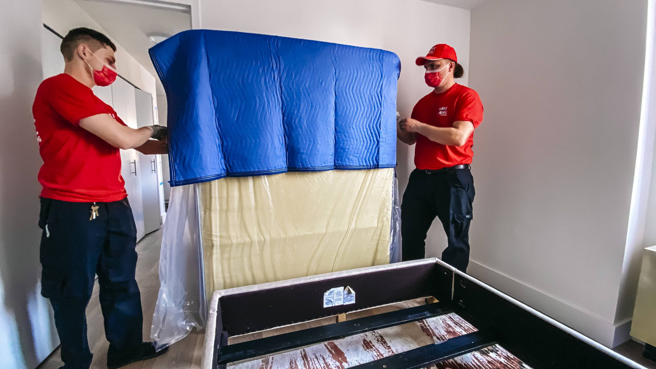 two guys packing a mattress