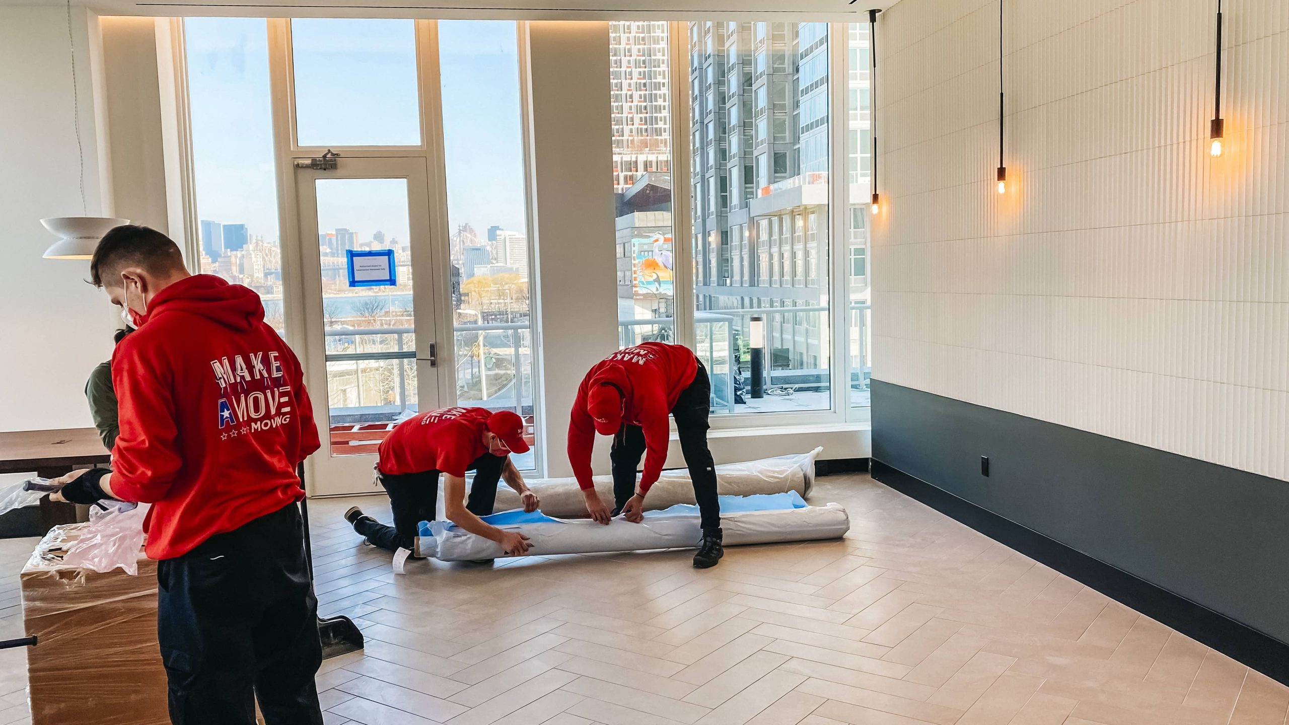 2 guys packing up the carpet