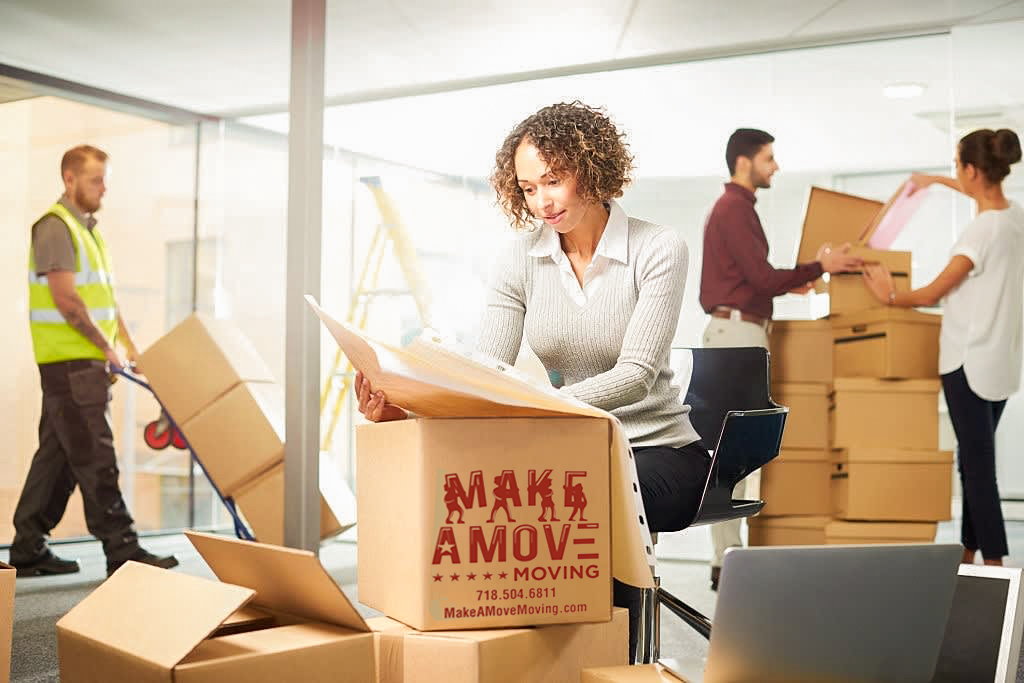 A team of four packing and transporting boxes