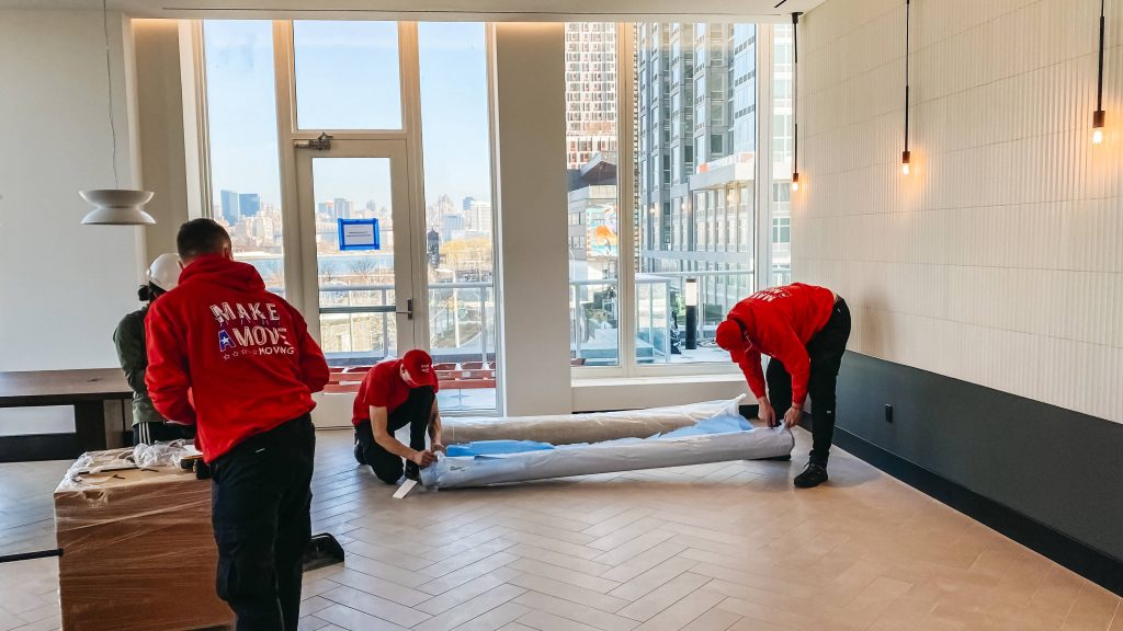 two guys packing a carpet