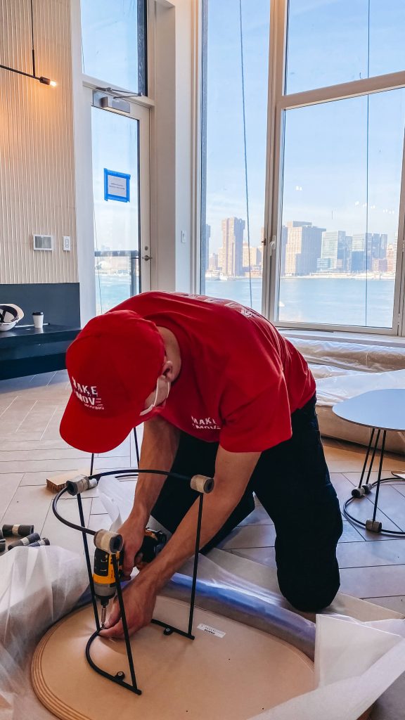 guy using drill to assemble a chair