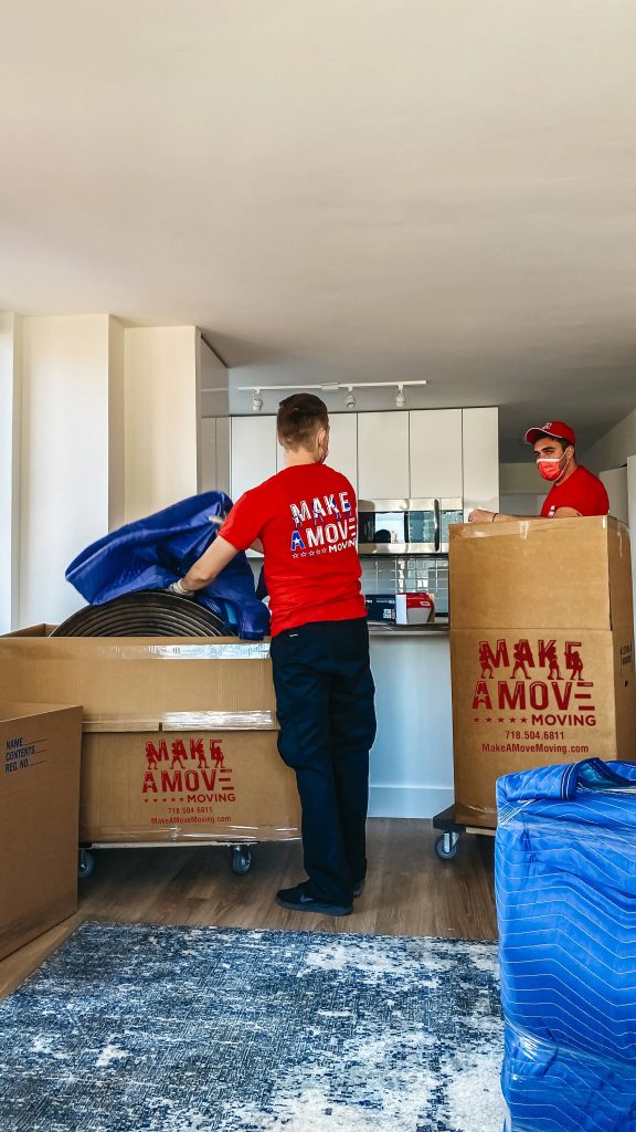 two guys packing items inside boxes