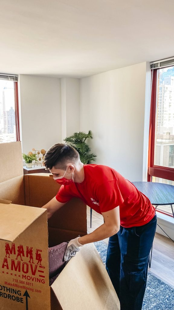 guy carefully packing items